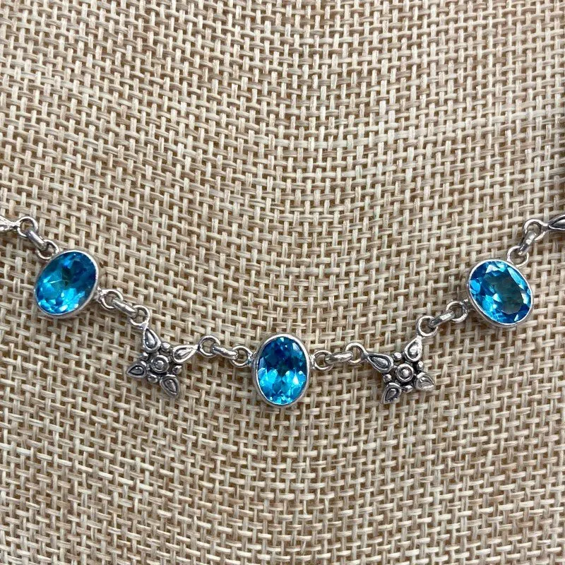 Sterling Silver Blue Topaz And Flower Necklace